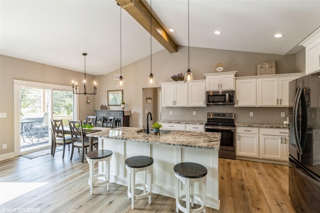 kitchen featuring appliances with stainless steel finishes, decorative light fixtures, white cabinetry, backsplash, and beam ceiling