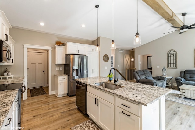 kitchen featuring white cabinetry, an island with sink, black dishwasher, electric range oven, and sink