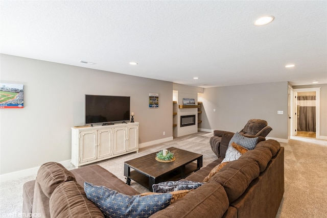 carpeted living room with a textured ceiling