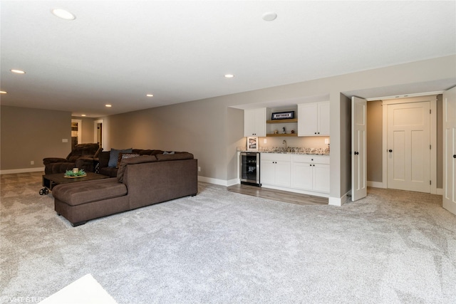 living room featuring wet bar, beverage cooler, and light carpet