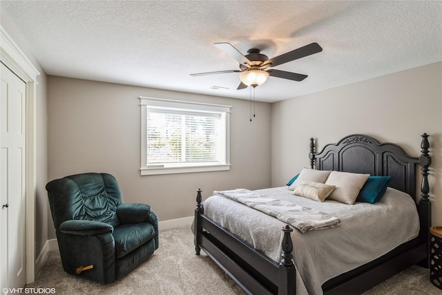 bedroom with a textured ceiling, ceiling fan, and carpet floors