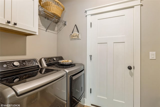 laundry room with cabinets and washing machine and clothes dryer