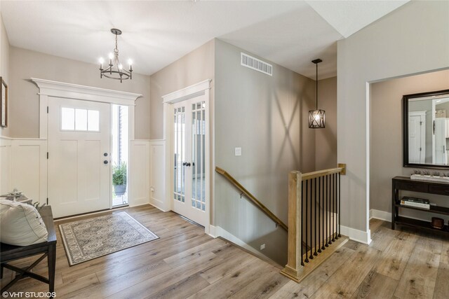 foyer featuring a chandelier and light hardwood / wood-style floors