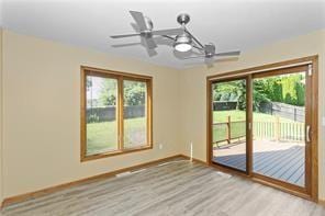 unfurnished dining area with ceiling fan and light hardwood / wood-style flooring