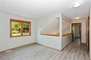 spare room featuring light hardwood / wood-style floors