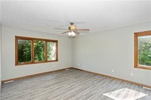 unfurnished room featuring light hardwood / wood-style floors and ceiling fan