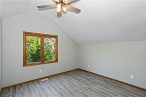 bonus room with lofted ceiling and wood-type flooring