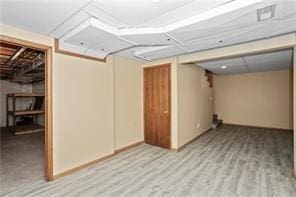 basement with light hardwood / wood-style flooring