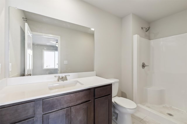 bathroom featuring vanity, toilet, and walk in shower