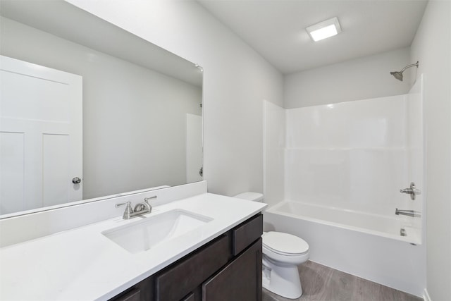 full bathroom featuring bathtub / shower combination, wood-type flooring, toilet, and vanity