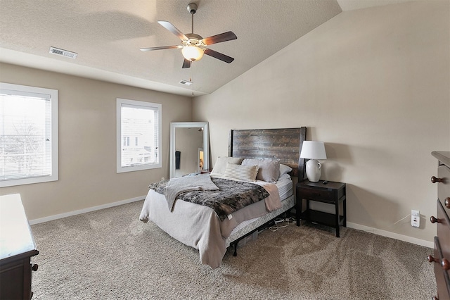 carpeted bedroom featuring ceiling fan, a textured ceiling, and lofted ceiling