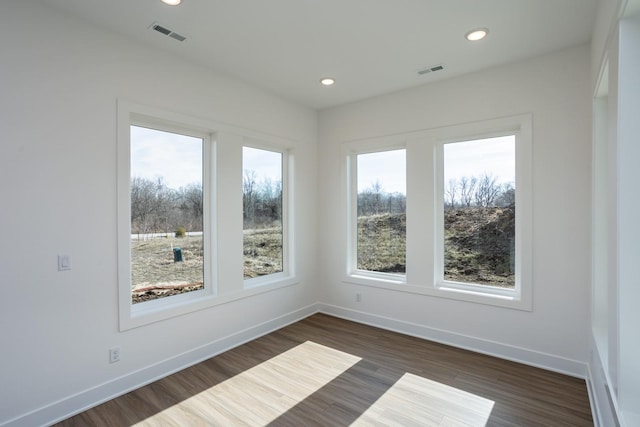 unfurnished room with dark wood-type flooring