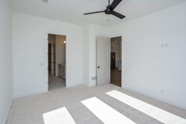 unfurnished bedroom featuring ensuite bathroom, light carpet, and black refrigerator with ice dispenser