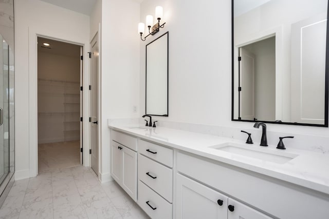 bathroom with vanity and a shower with door