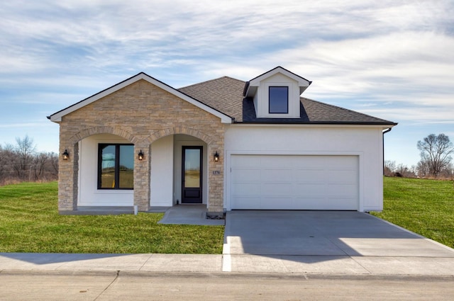 view of front of property featuring a garage and a front yard