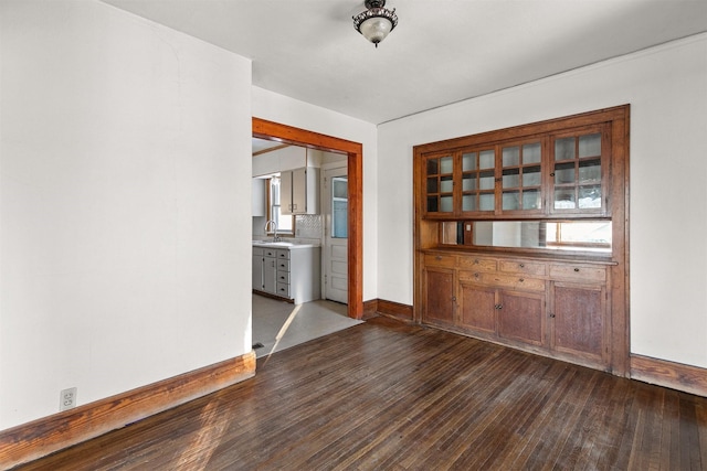 spare room featuring dark hardwood / wood-style flooring and sink