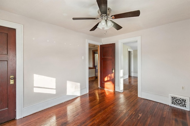 empty room featuring ceiling fan and dark wood-type flooring