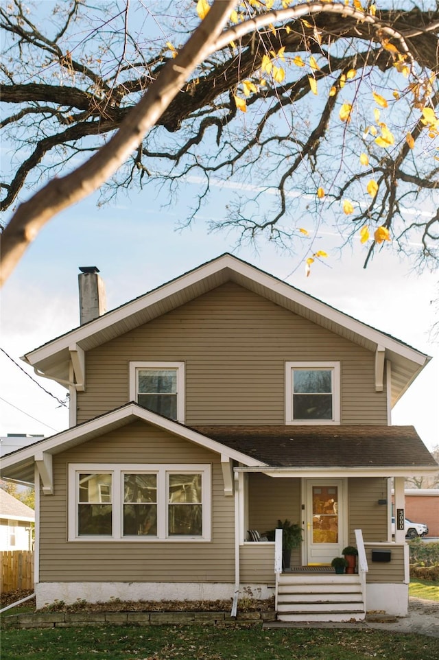 rear view of property with covered porch