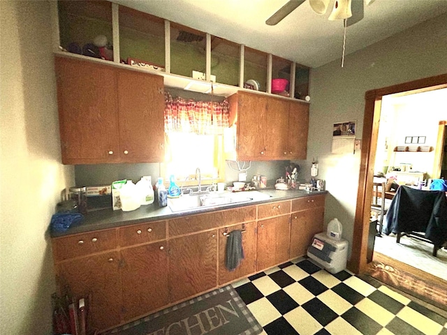 kitchen featuring ceiling fan and sink