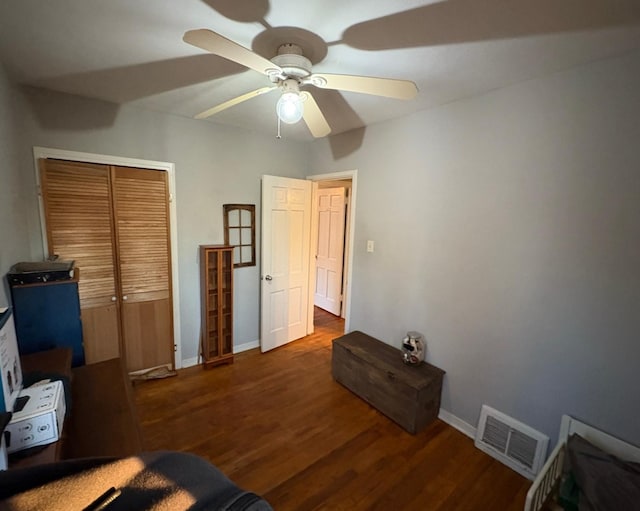 bedroom with ceiling fan, a closet, and dark hardwood / wood-style flooring