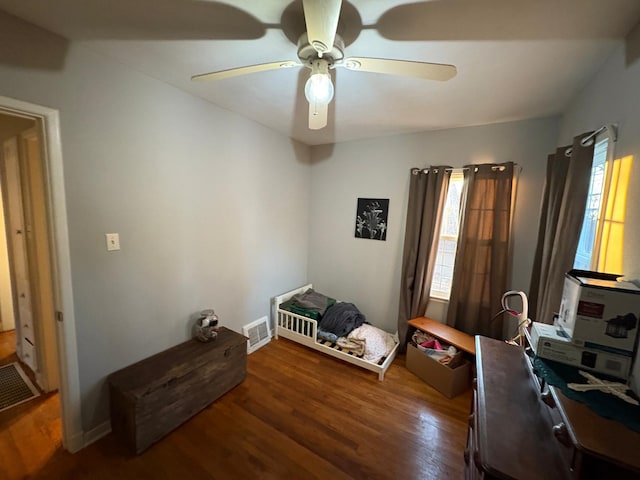 bedroom with ceiling fan and dark hardwood / wood-style flooring