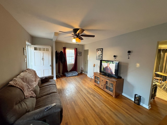 living room featuring ceiling fan and hardwood / wood-style floors