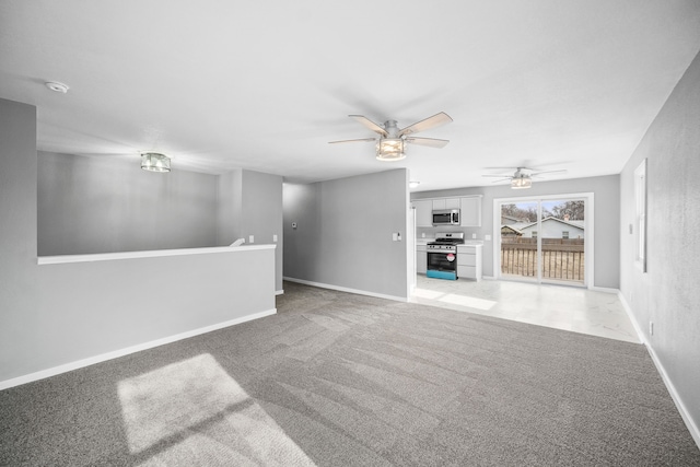 unfurnished living room with ceiling fan and light colored carpet