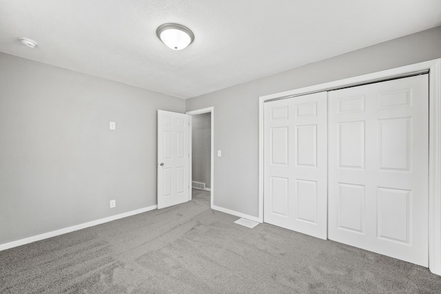 unfurnished bedroom with a closet and carpet flooring