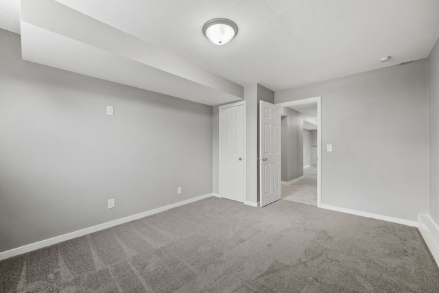 interior space with a textured ceiling and carpet floors