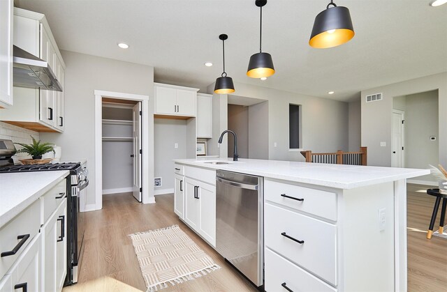 kitchen featuring white cabinets, appliances with stainless steel finishes, and sink