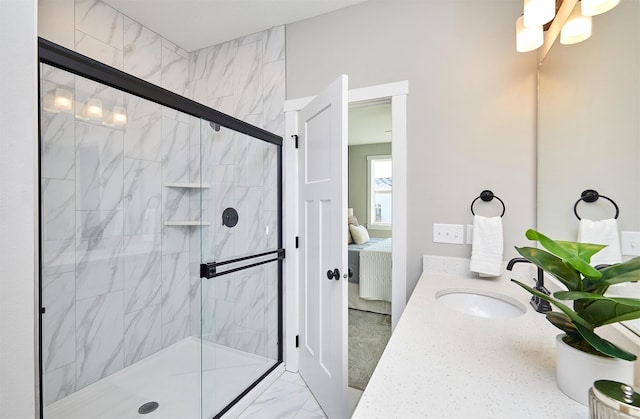 bathroom featuring a shower with door and sink