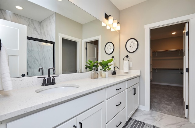 bathroom with walk in shower and vanity