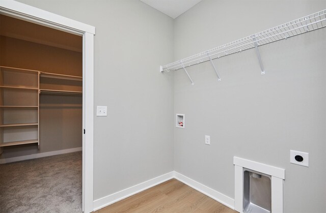 laundry area featuring wood-type flooring, hookup for a washing machine, and hookup for an electric dryer