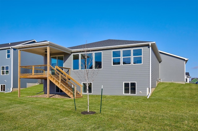 rear view of house featuring a wooden deck, a yard, and ceiling fan