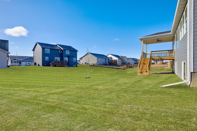 view of yard featuring ceiling fan and a deck