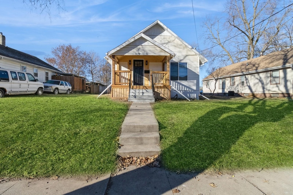 bungalow-style home featuring a front yard