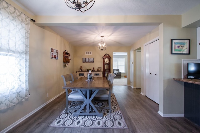 dining space featuring a chandelier and dark hardwood / wood-style flooring