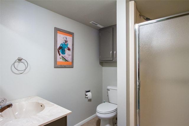 bathroom with tile patterned floors, toilet, vanity, and walk in shower