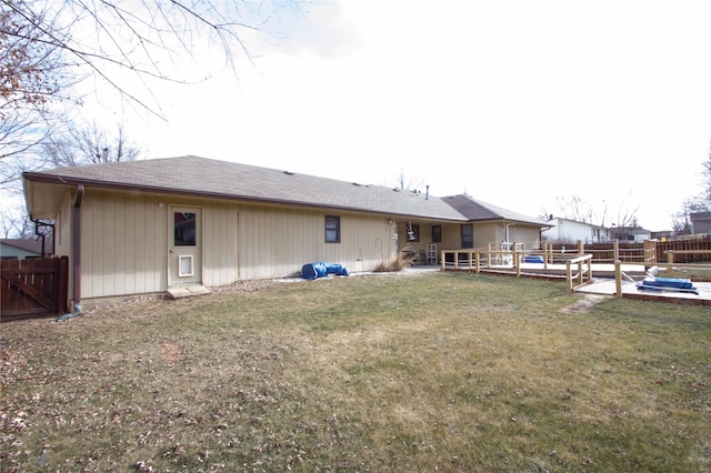 rear view of house featuring a patio area and a yard