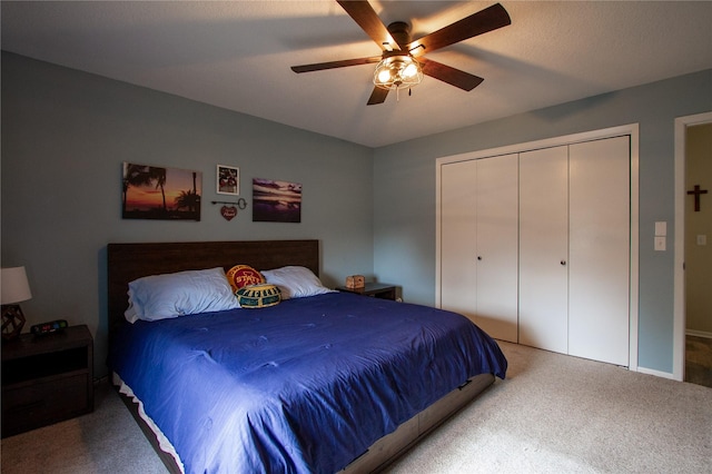 carpeted bedroom featuring ceiling fan and a closet