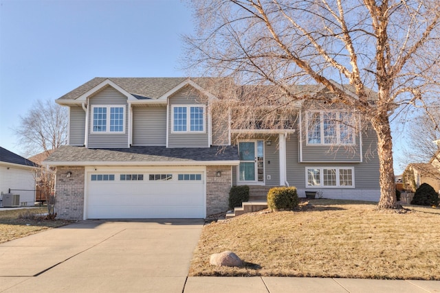 view of front of home featuring a garage and central air condition unit