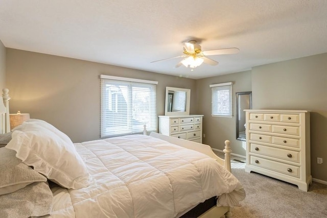 bedroom with ceiling fan and light colored carpet