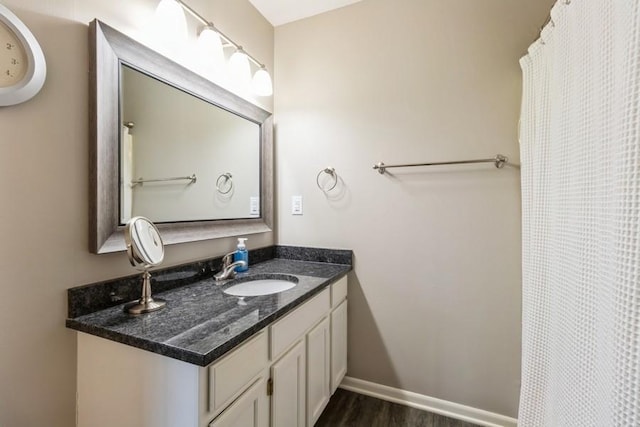 bathroom featuring hardwood / wood-style flooring and vanity