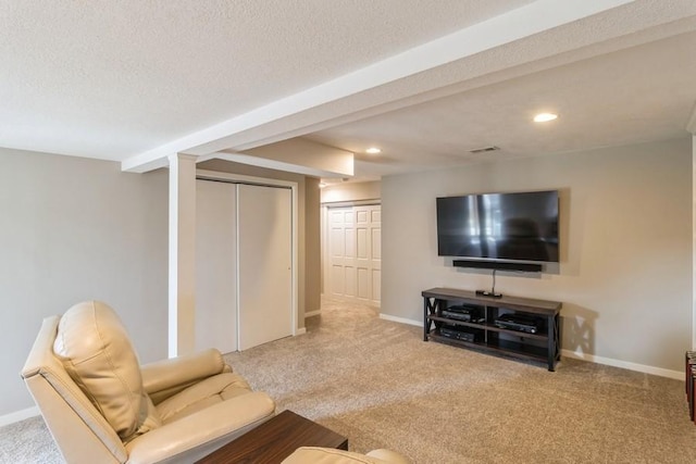 carpeted living room featuring a textured ceiling