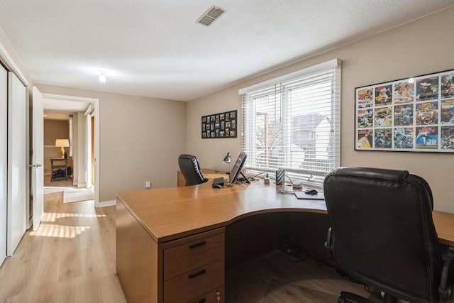 office with light hardwood / wood-style flooring