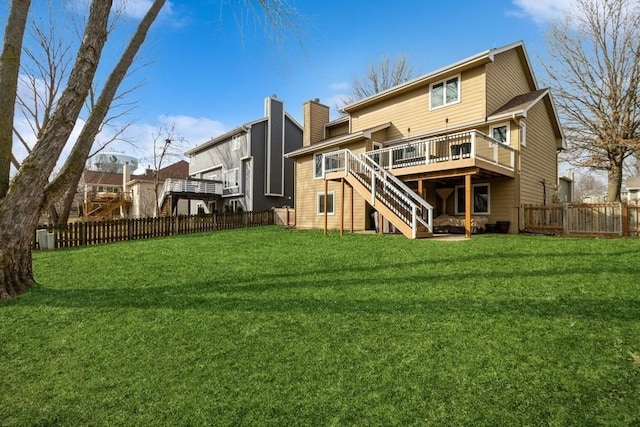 back of house with a deck and a yard