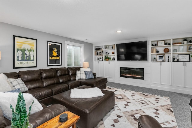 carpeted living room featuring built in shelves and a large fireplace