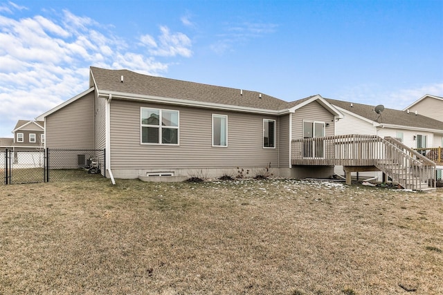 back of house with a deck and a yard