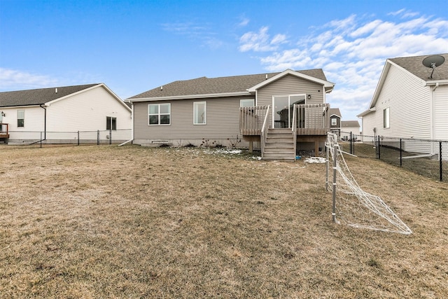 rear view of property with a deck and a lawn