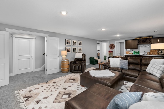 living room with indoor bar and light colored carpet